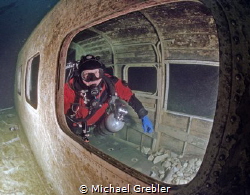 Diver inside airplane wreck in Morrison's Quarry under th... by Michael Grebler 